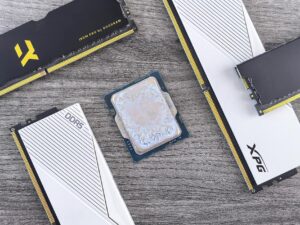 Detailed shot of DDR5 RAM modules and a CPU on a wooden table, highlighting computer hardware.